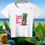 The Tropical State of Mind crop top on a hanger against an island shoreline