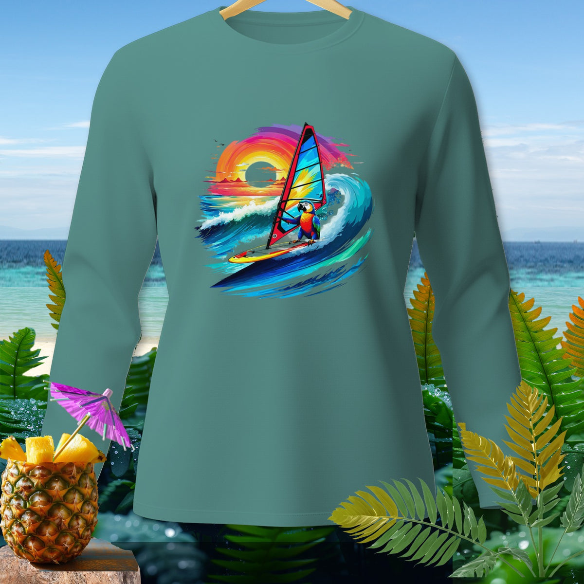 Teal long-sleeve shirt with a parrot windsurfing on a wave at sunset.