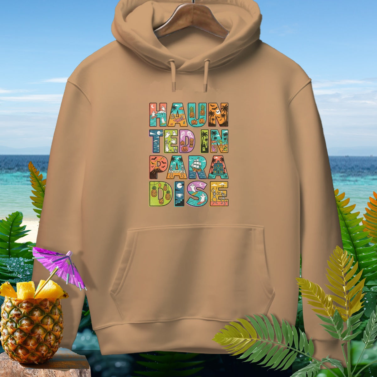 Brown hoodie with "Haunted in Paradise" Halloween text design.