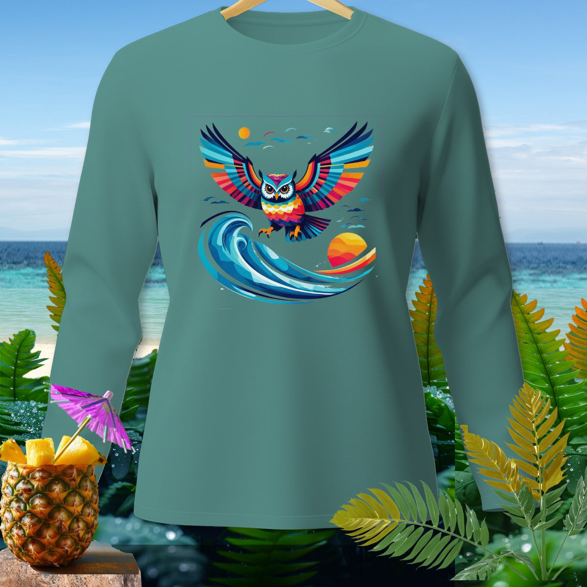Teal long-sleeve shirt featuring a colorful owl flying over a wave.