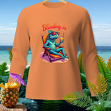Orange long-sleeve shirt with a cartoon chameleon on a beach chair and text 