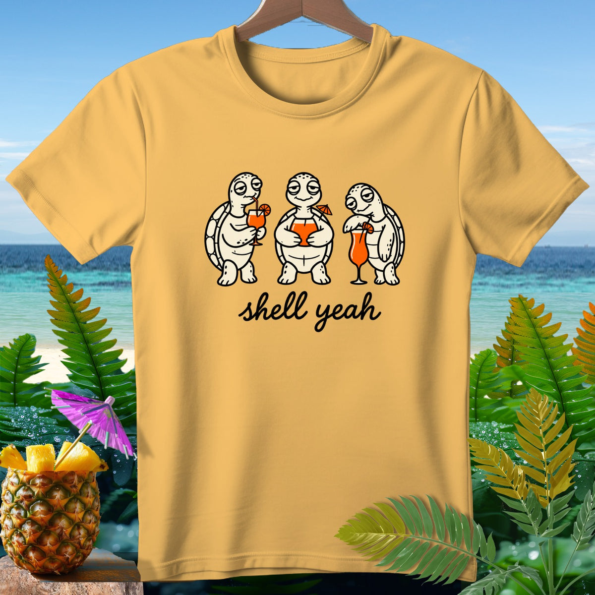 Yellow t-shirt with cartoon turtles holding cocktails and the text "shell yeah".