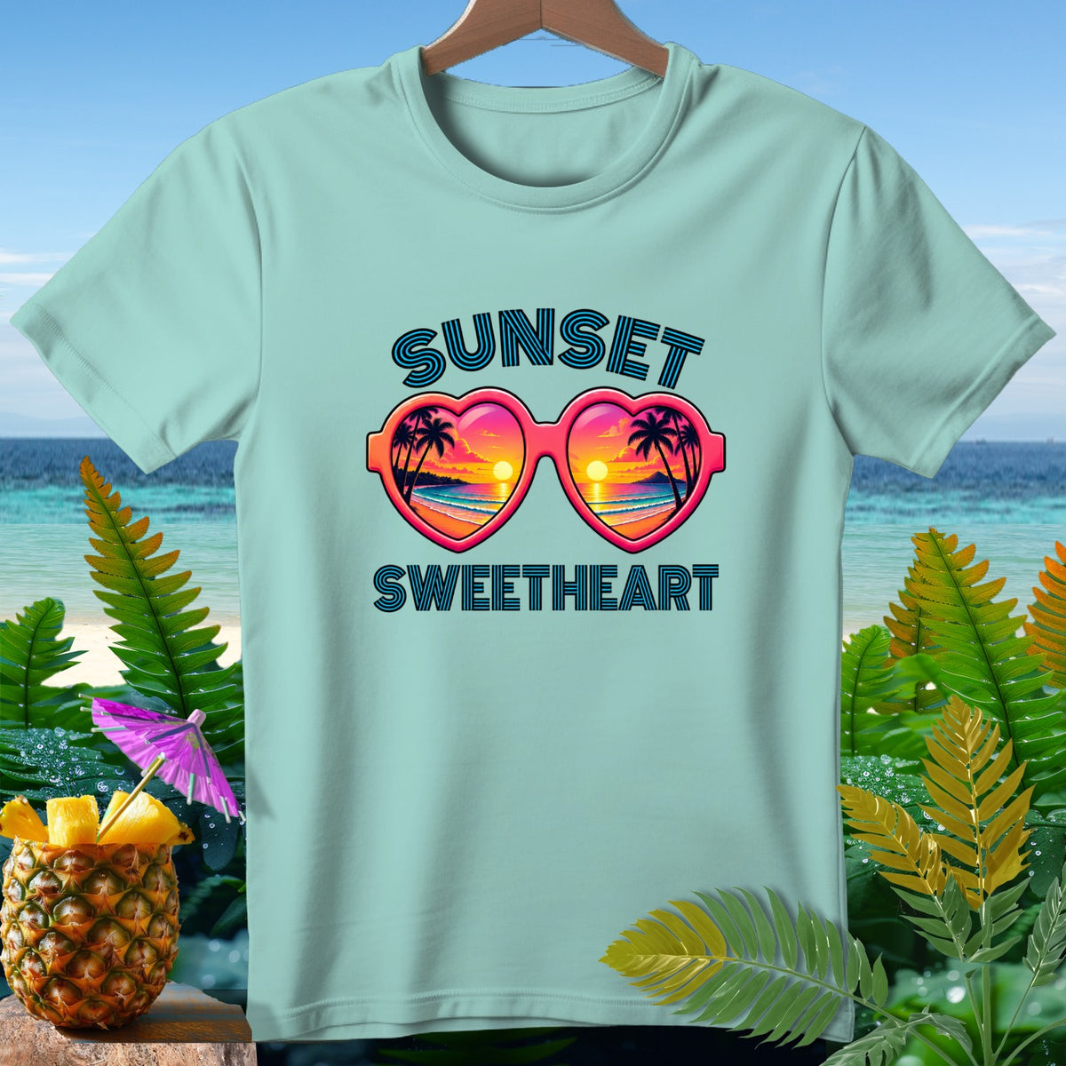 Light blue t-shirt with "SUNSET SWEETHEART" and heart-shaped sunglasses graphic.