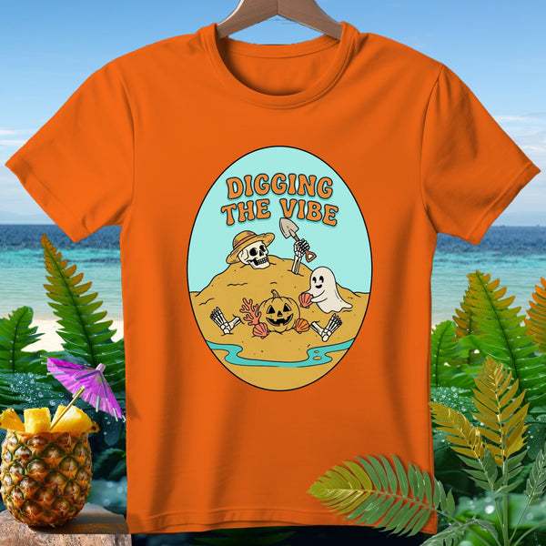 Orange t-shirt with "Digging the Vibe" text and Halloween beach scene.