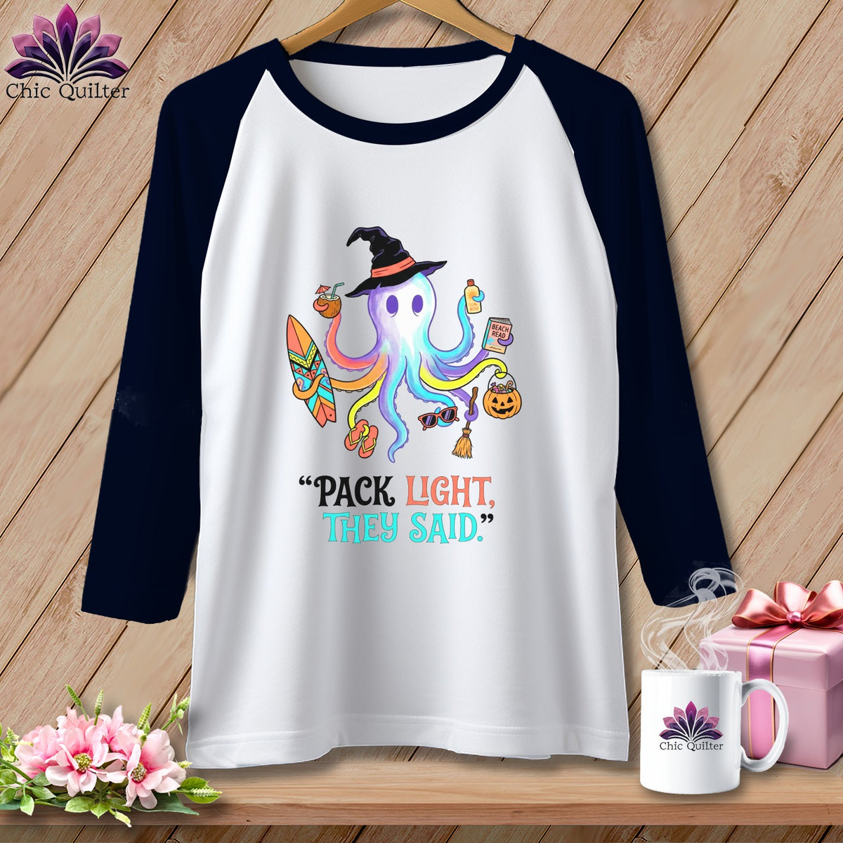 White baseball tee with colorful octopus in witch hat, text "PACK LIGHT, THEY SAID."