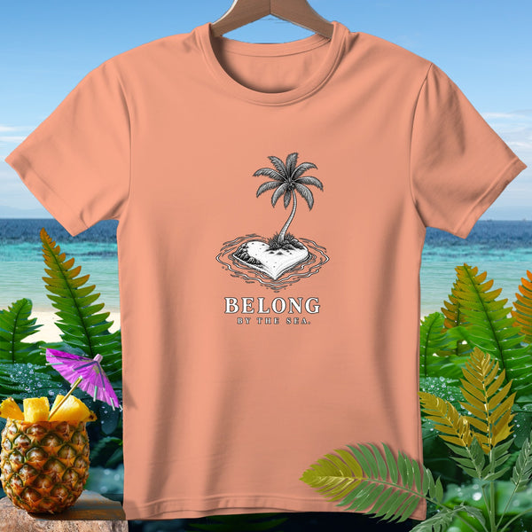 Peach t-shirt with "Belong By The Sea" text and a heart-shaped island.