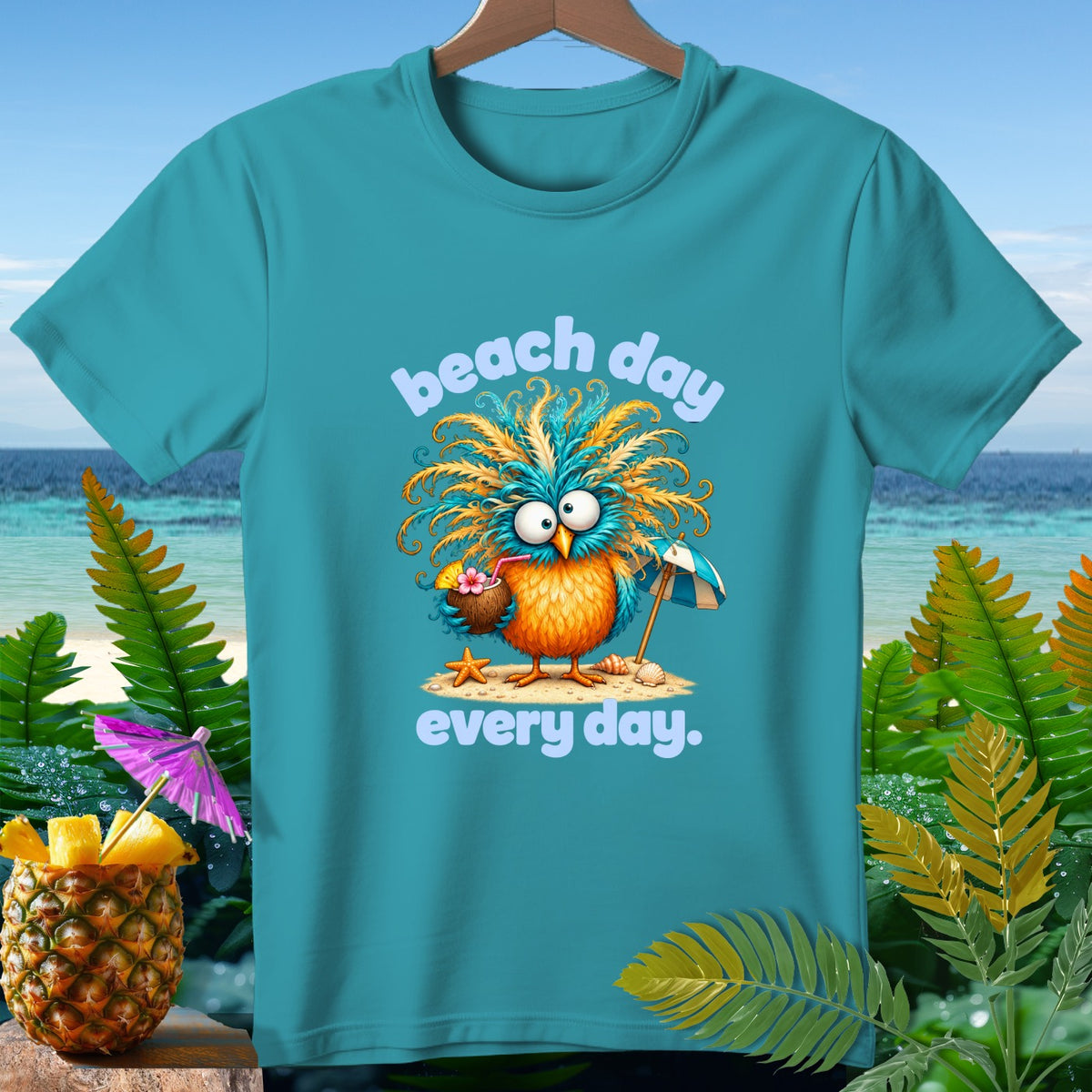 Turquoise t-shirt with cartoon bird, coconut drink, umbrella, and text "beach day every day."
