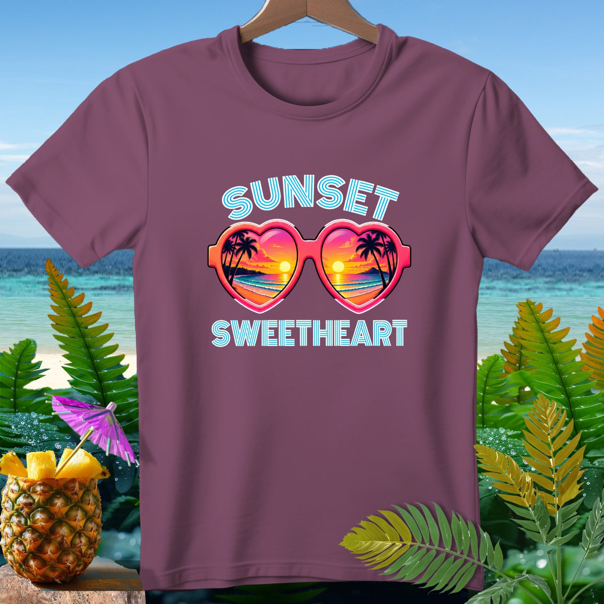 Plum t-shirt with "Sunset Sweetheart" text and heart-shaped sunglasses.