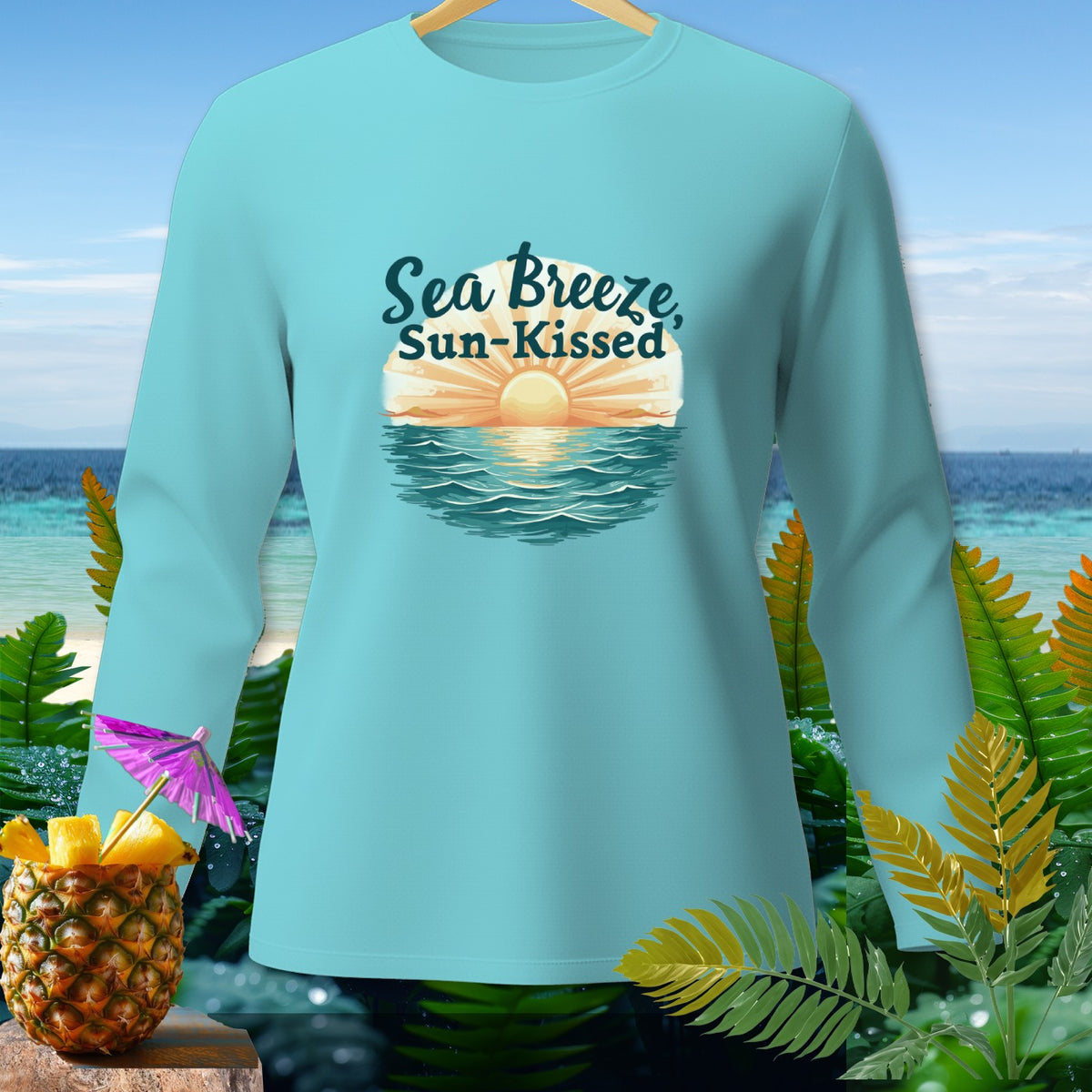 Teal long-sleeve shirt with "Sea Breeze, Sun-Kissed" text and a sunset graphic.