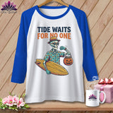 Skeleton in hat and sunglasses holds surfboard and pumpkin candy bucket.
