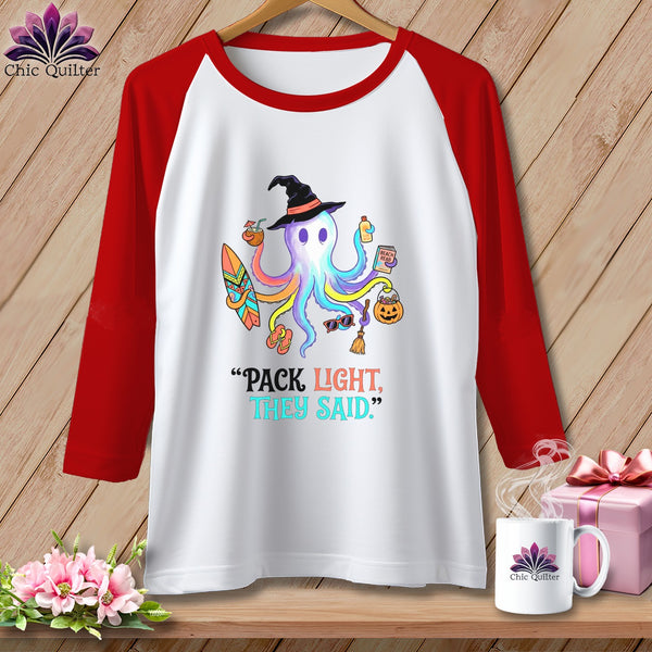 White raglan t-shirt with colorful octopus wearing a witch hat and holding beach items.
