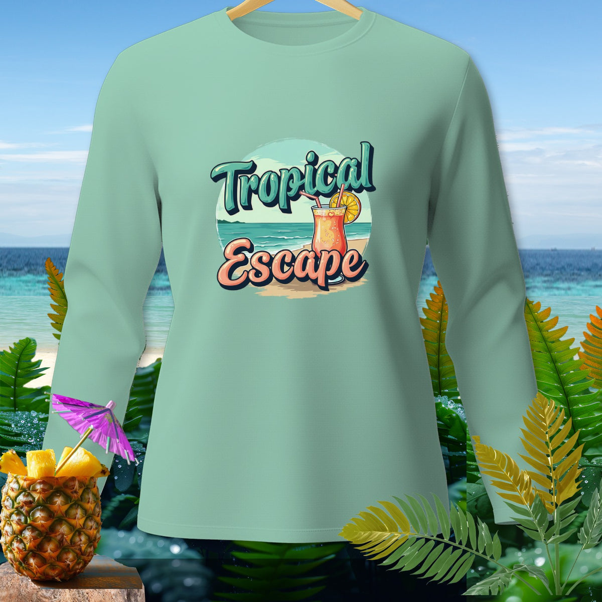Mint green long sleeve shirt with "Tropical Escape" graphic and tropical imagery.