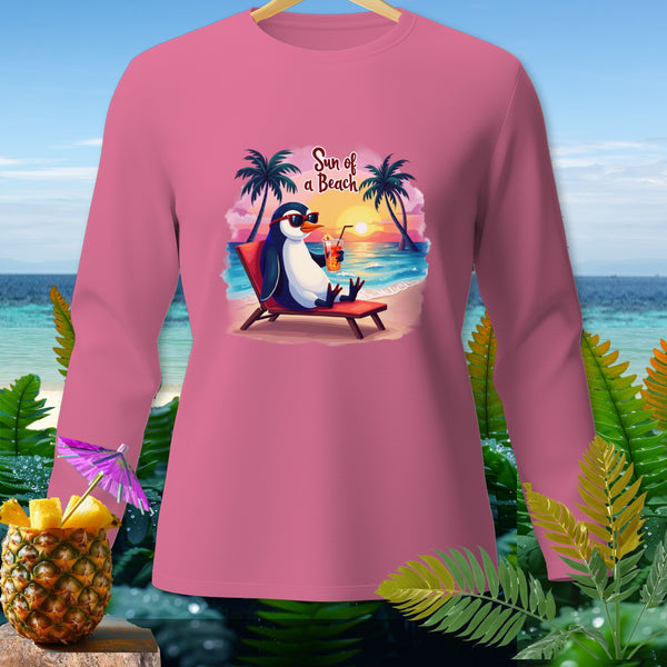 Pink long-sleeved shirt featuring a penguin on a beach with palm trees and text "Sun of a Beach".