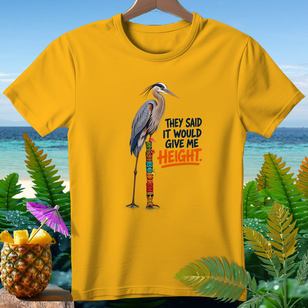 Yellow t-shirt with a heron on a tiki pole, text "THEY SAID IT WOULD GIVE ME HEIGHT."