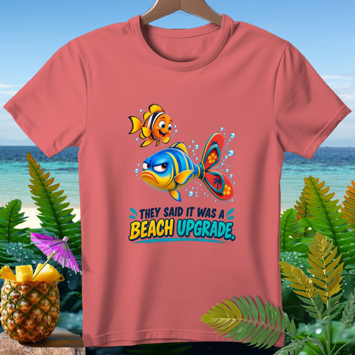 Coral t-shirt with cartoon fish and text "They said it was a beach upgrade."