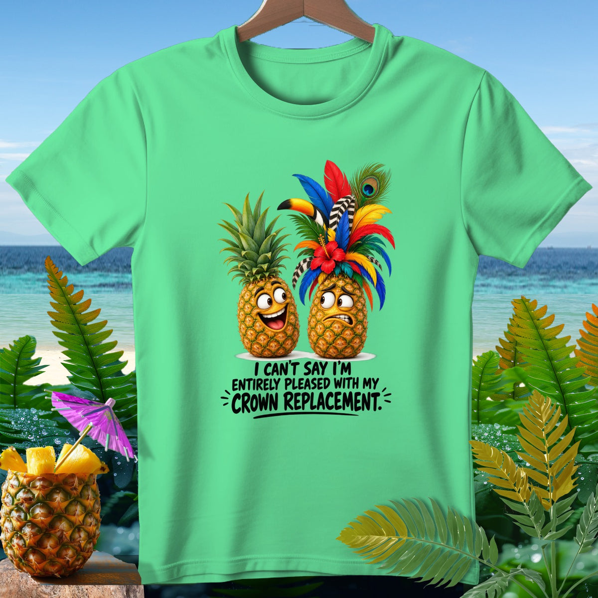 Two cartoon pineapples on a green t-shirt with text that reads "I can't say I'm entirely pleased with my crown replacement."