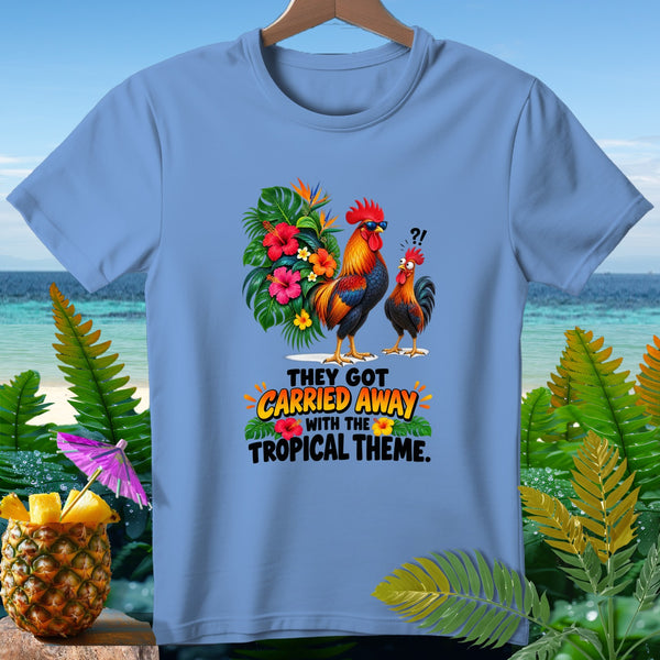 Light blue t-shirt with two roosters, tropical flowers, and text "THEY GOT CARRIED AWAY WITH THE TROPICAL THEME."