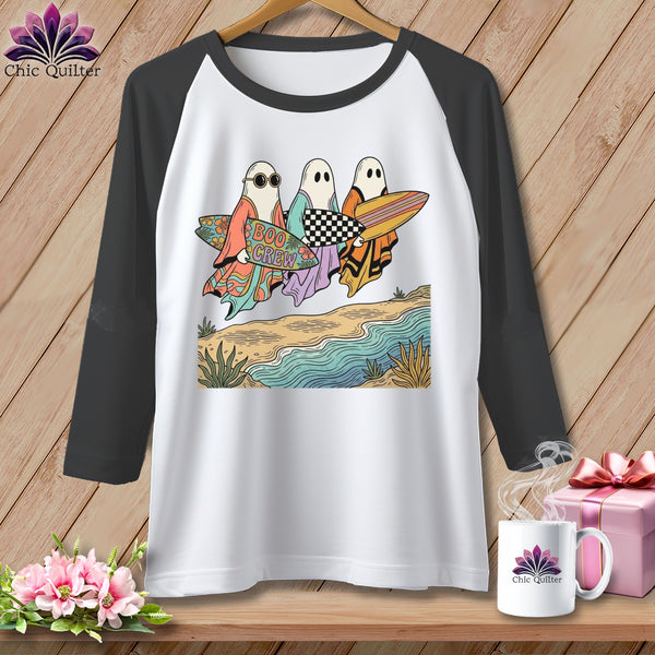 Three ghosts with surfboards on the beach, one holding "Boo Crew" sign.