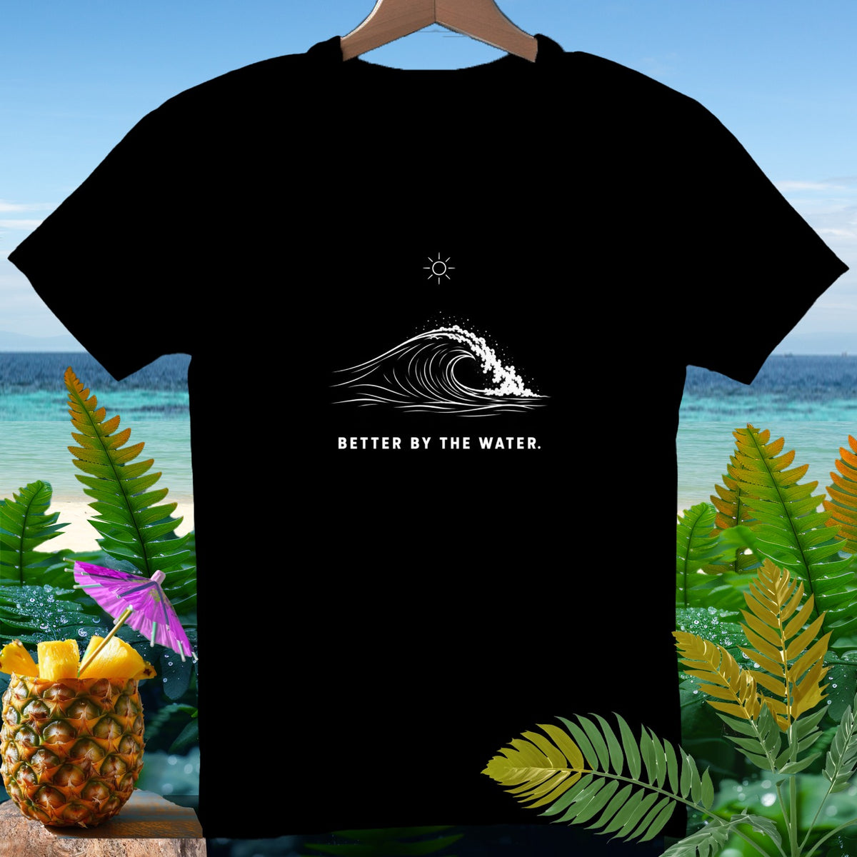 Black t-shirt with a white wave graphic and the text "BETTER BY THE WATER."