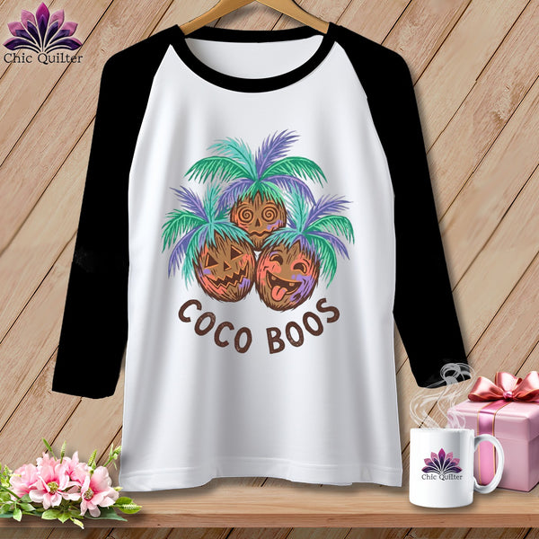 Raglan t-shirt with cartoon coconuts under palm fronds and text "Coco Boos".