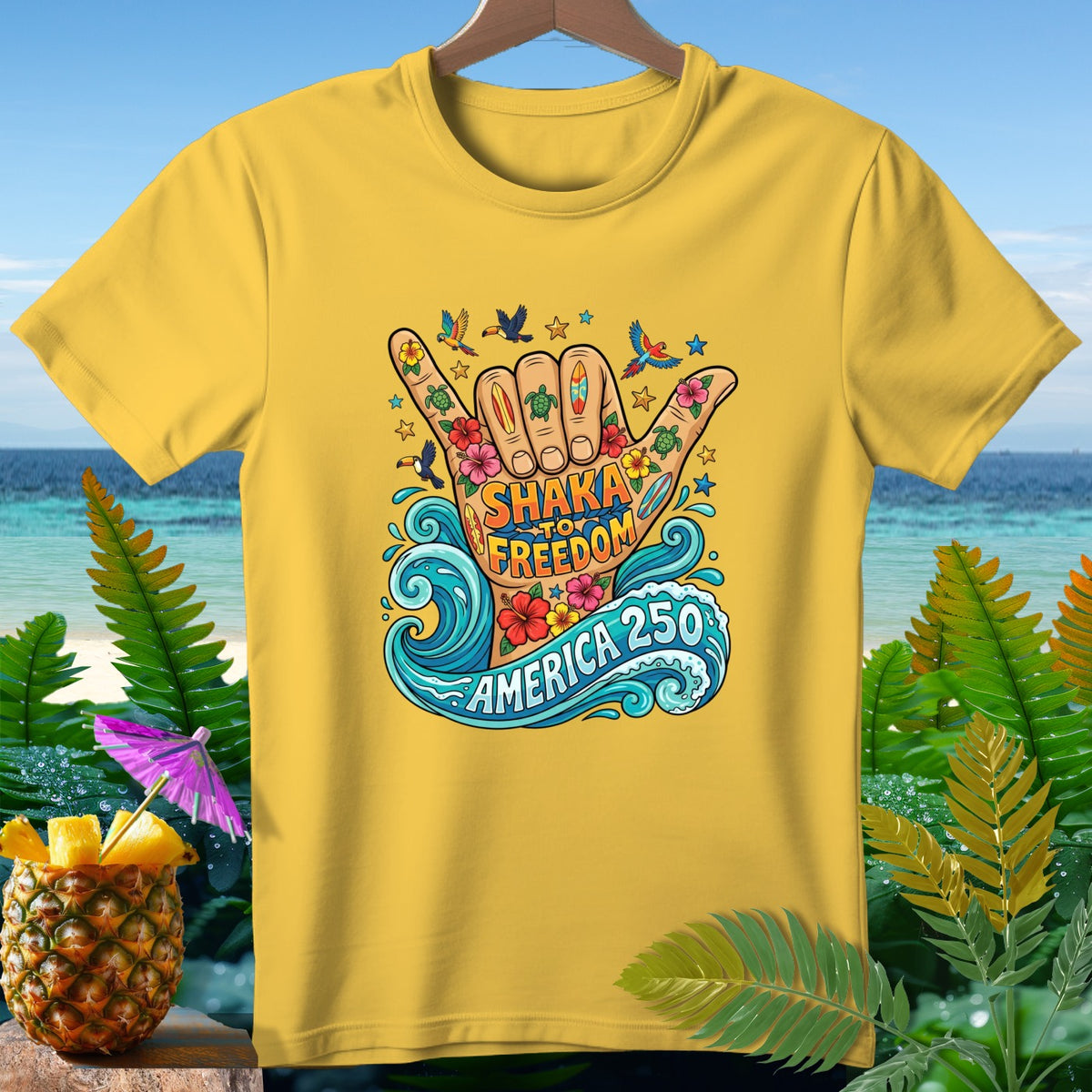 Yellow t-shirt with "Shaka to Freedom America 250" graphic featuring hand, waves, and tropical elements.