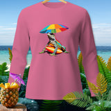 Pink long-sleeve shirt with a colorful iguana on a surfboard under an umbrella.