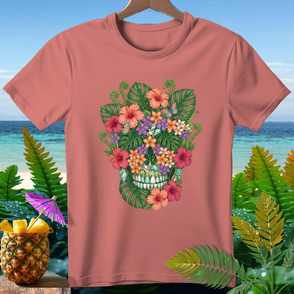 Coral t-shirt with tropical skull floral design and butterflies, against a beach background.