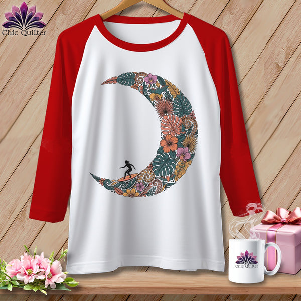 White t-shirt with red sleeves and a floral moon design with a surfer.
