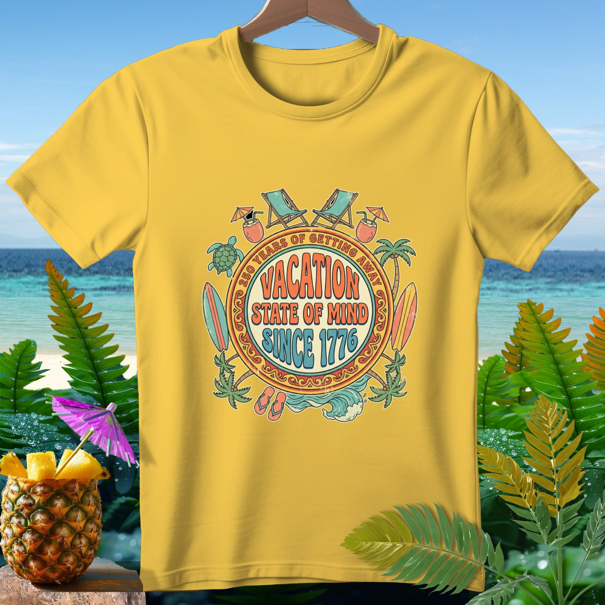 Yellow t-shirt with tropical "Vacation State of Mind Since 1776" graphic.