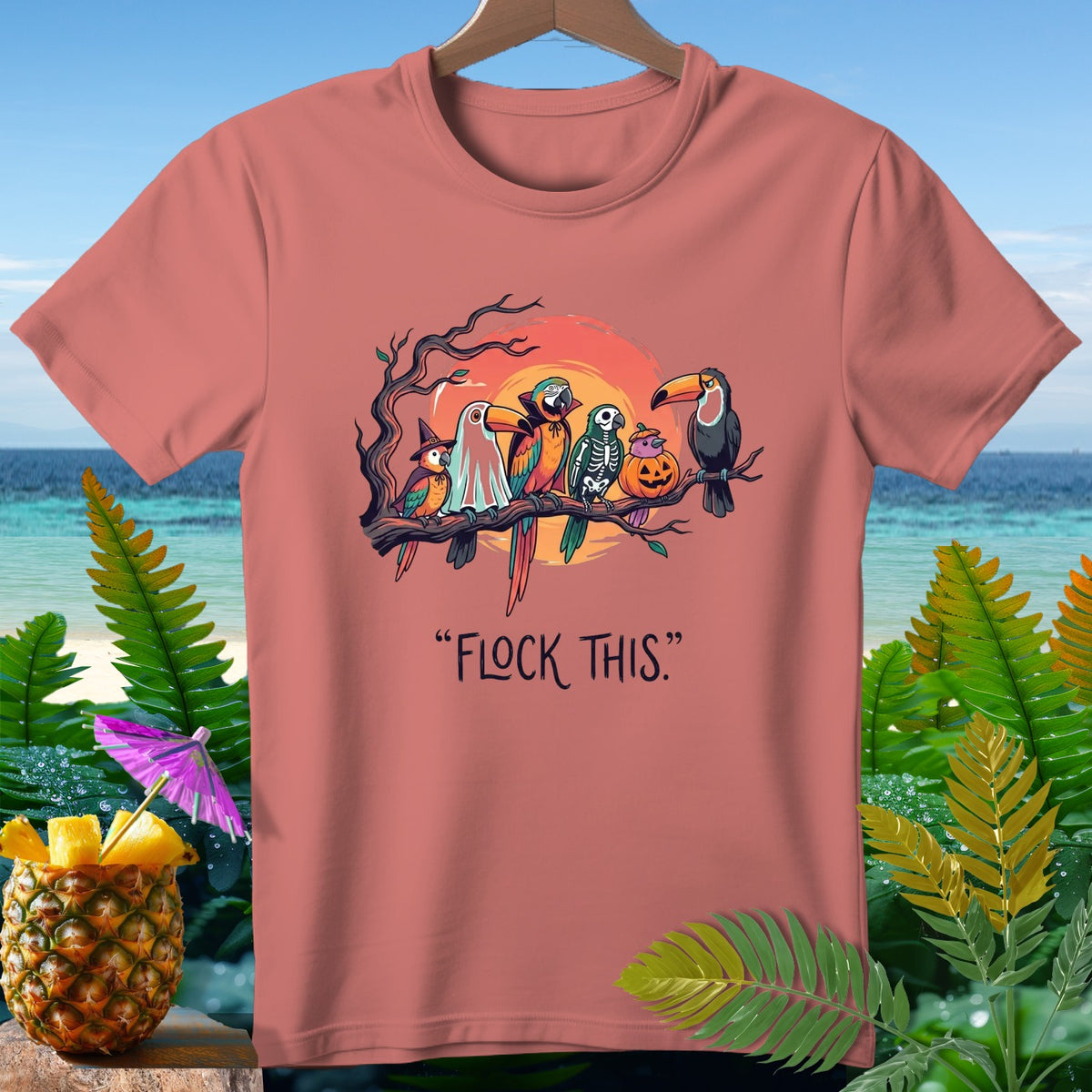 Parrots dressed for Halloween sit on a branch, with the text "FLOCK THIS."