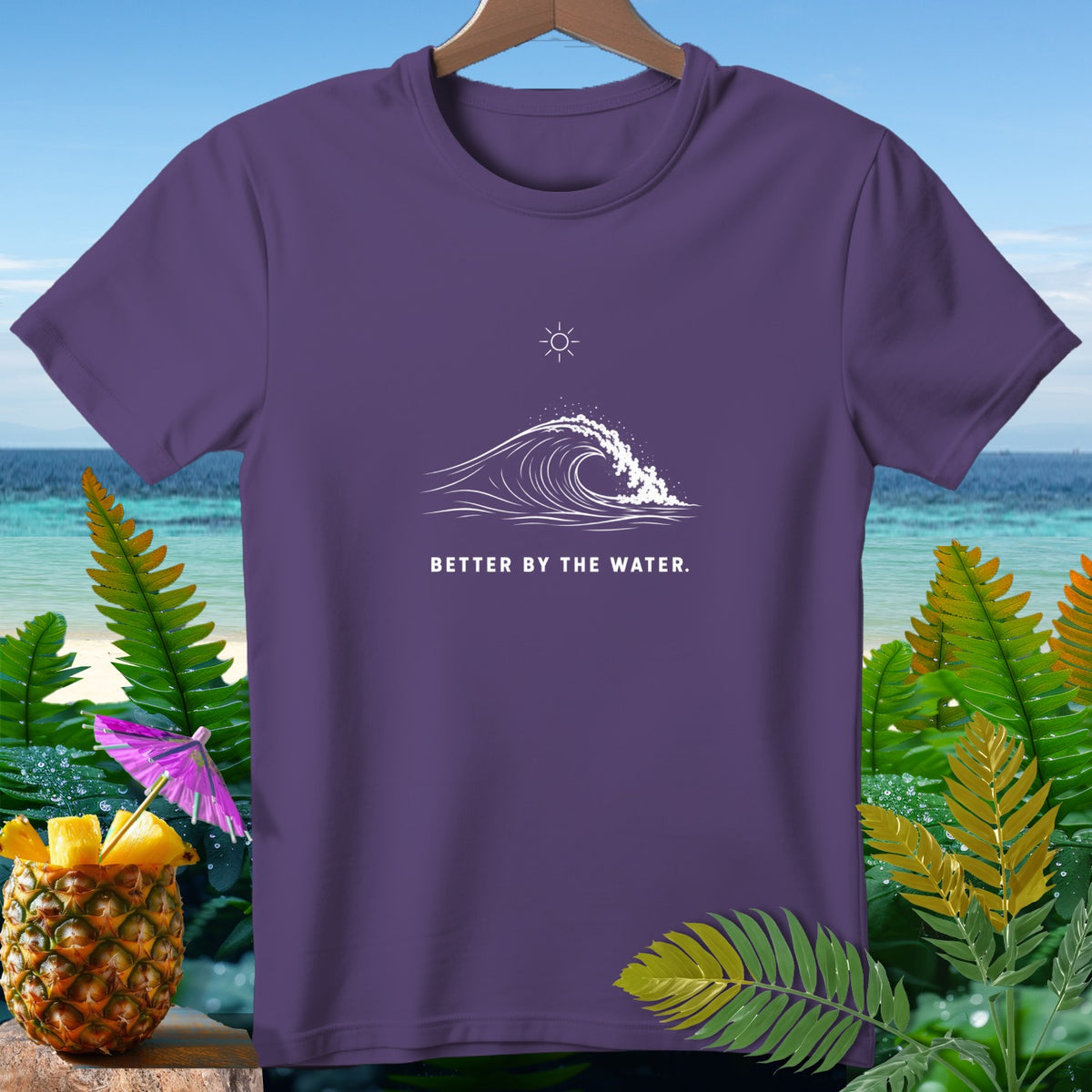 Purple t-shirt with white wave graphic and text "BETTER BY THE WATER."