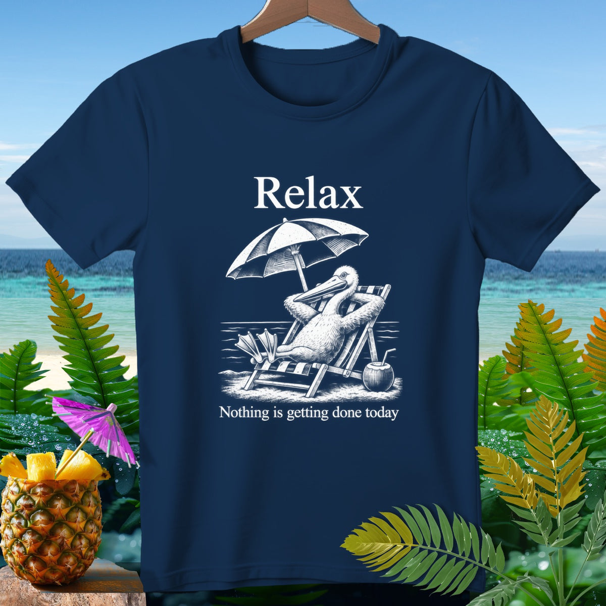 Navy t-shirt with a pelican relaxing on a beach chair, text "Relax" and "Nothing is getting done today".