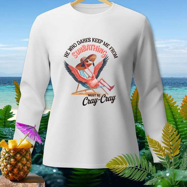 White long-sleeve shirt with a flamingo sunbathing and text "SUNBATHING MUST BE Cray-Cray".