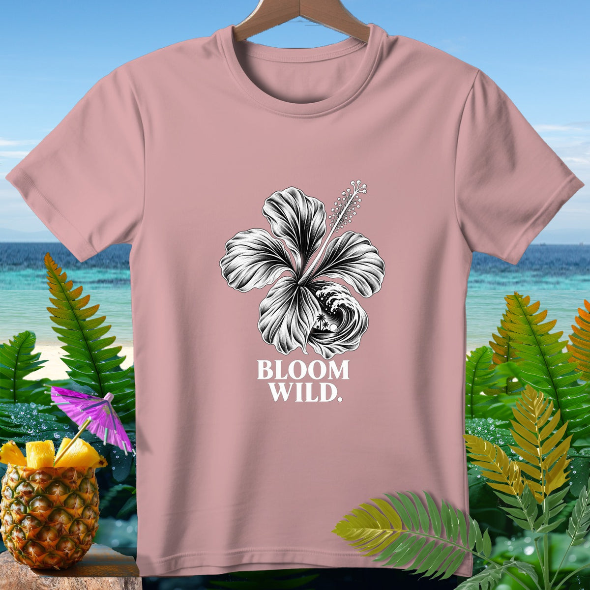 Pink t-shirt with black and white hibiscus flower graphic and "BLOOM WILD." text.