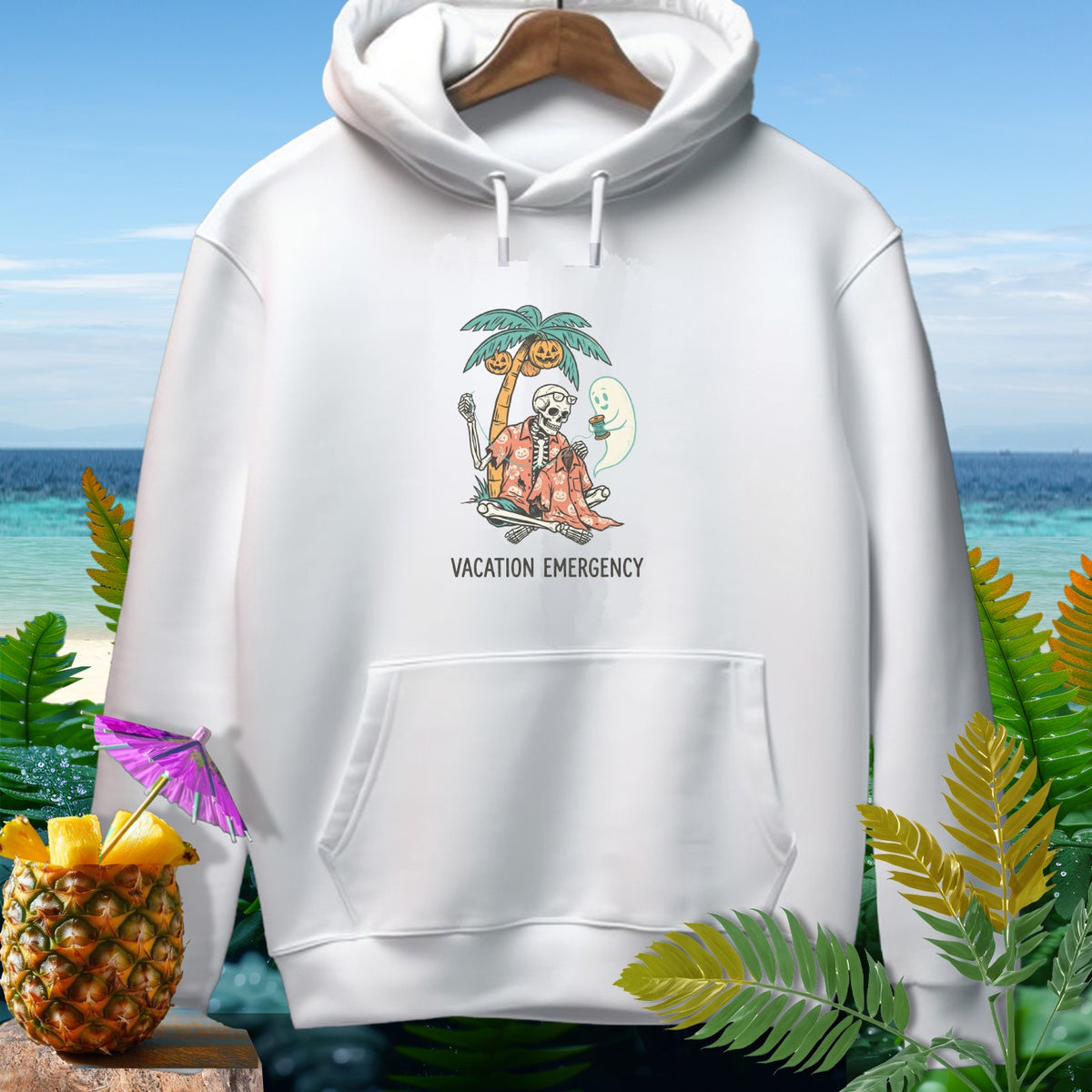 White hoodie with skeleton, ghost, palm tree, and "Vacation Emergency" text.