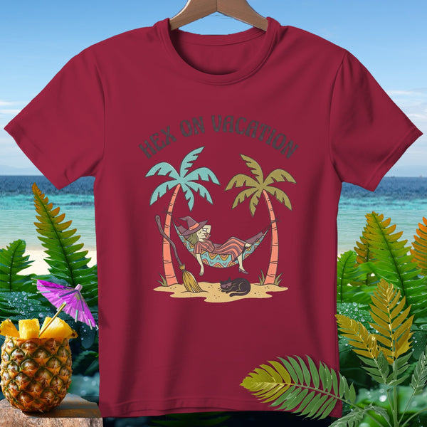 Maroon t-shirt with witch relaxing in hammock, text "Hex on Vacation".