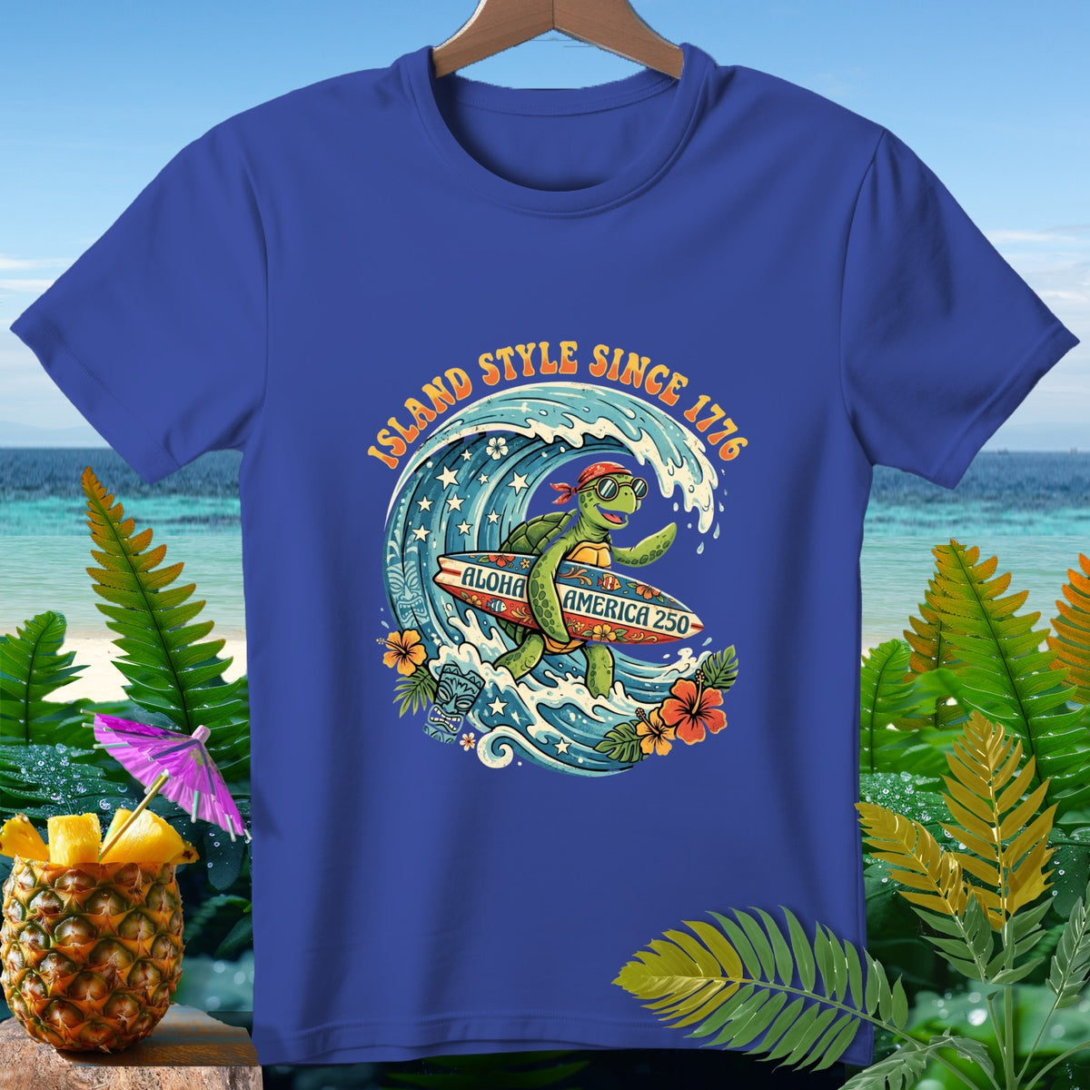 Blue t-shirt with cartoon turtle surfing a wave, "Island Style Since 1776", and "Aloha America 250".