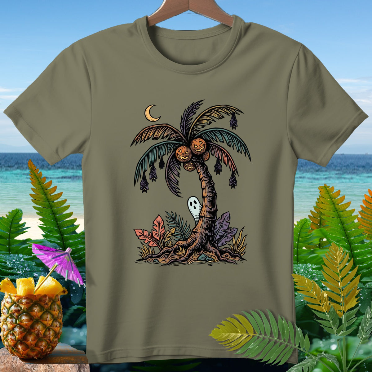 Olive t-shirt with Halloween palm tree graphic featuring pumpkins, bats, and a ghost.