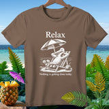 Brown t-shirt with white graphic of pelican relaxing on beach chair under umbrella with text 