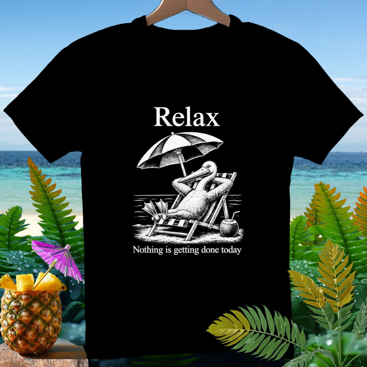 Black t-shirt with a pelican on a lounge chair under an umbrella, text "Relax Nothing is getting done today".