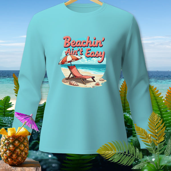 Light blue long-sleeve shirt with "Beachin' Ain't Easy" graphic on a beach scene.