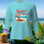 Light blue long-sleeve shirt with "Beachin' Ain't Easy" graphic on a beach scene.