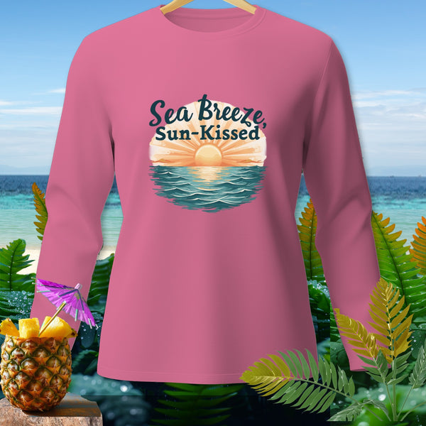 Pink long-sleeved shirt with "Sea Breeze, Sun-Kissed" graphic and tropical background.