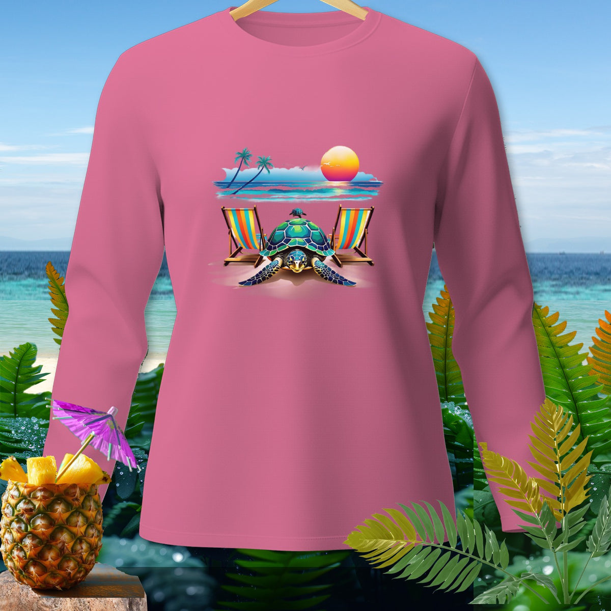 Pink long-sleeved shirt with a tropical beach scene featuring a turtle, chairs, and sunset.