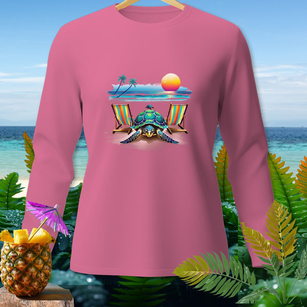 Pink long-sleeved shirt with a tropical beach scene featuring a turtle, chairs, and sunset.