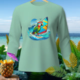 Mint green long-sleeve shirt with a parrot windsurfing graphic and tropical background.