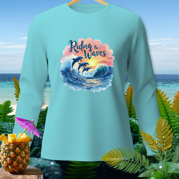 Light blue long-sleeve shirt with dolphins riding waves graphic and "Riding the Waves" text.