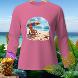 Pink long-sleeve shirt with beach scene graphic featuring umbrella, chair, and starfish.