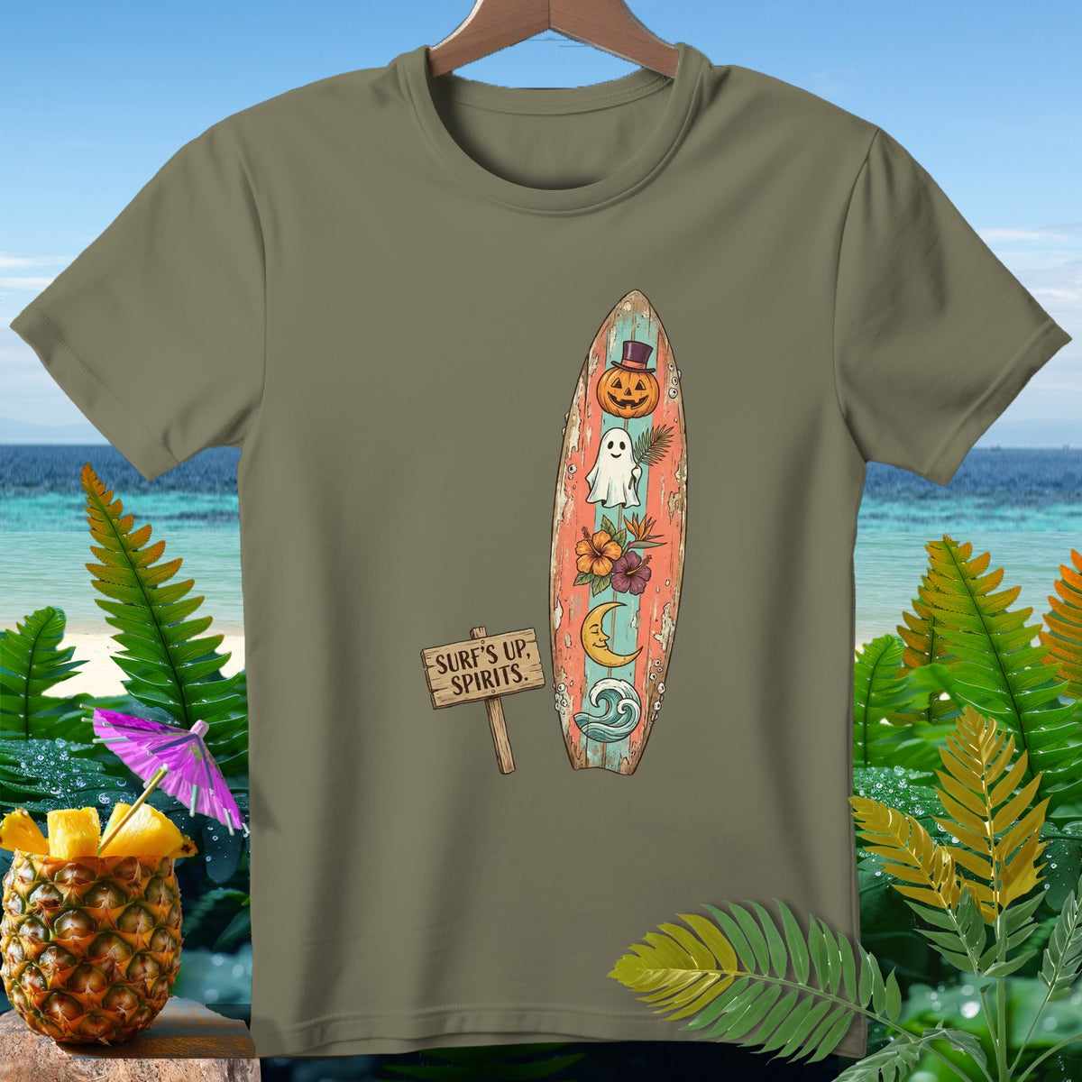 Green t-shirt with surfboard graphic featuring Halloween elements and beach scene.