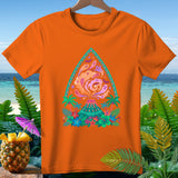 Orange t-shirt with a colorful graphic of a volcano, ghosts, bats, and tropical foliage.